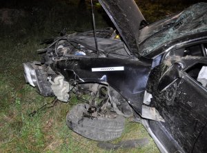 Nocą widać rozbity samochód.