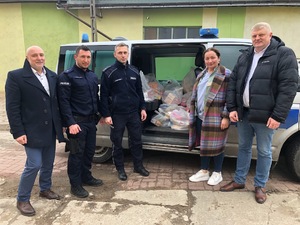 Pamiątkowe zdjęcie na tle radiowozu.