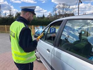 Policjant sprawdza stan trzeźwości kierowcy.